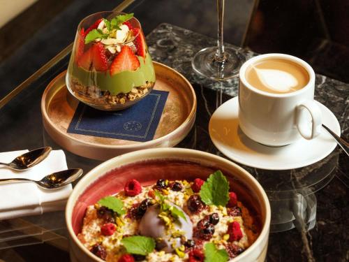 a table with two bowls of food and a cup of coffee at Fairmont Royal York Hotel in Toronto