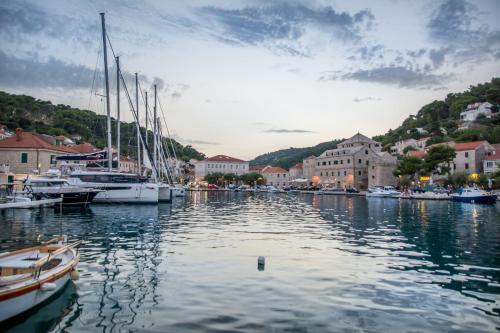 a group of boats docked in a harbor with buildings at Rooms Bed and Breakfast Blanc in Pučišća