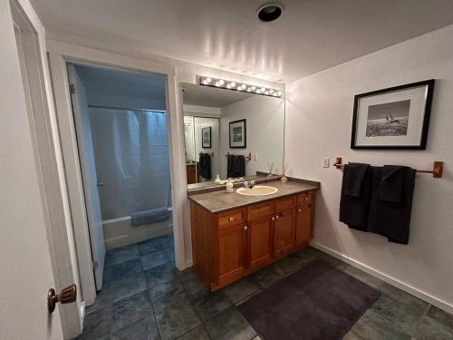 a bathroom with a sink and a mirror at New Management - Collingwood Getaway in Collingwood