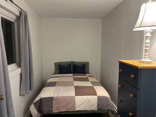 a bedroom with a bed and a dresser and a window at New Management - Collingwood Getaway in Collingwood