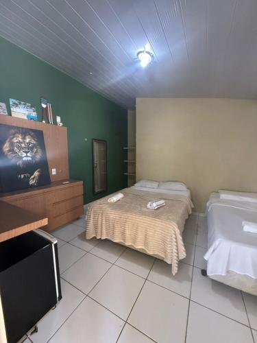 Ένα ή περισσότερα κρεβάτια σε δωμάτιο στο Pousada pipa meu amor