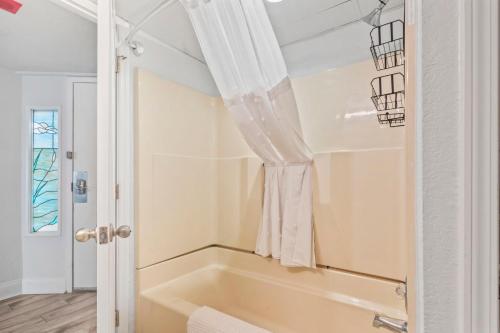 a bath tub in a bathroom with a window at Ocean Front at Beach Cove in Myrtle Beach