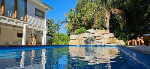 a swimming pool in front of a house at Complejo Pelicano Chapadmalal in Chapadmalal