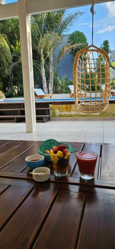a table with bowls of fruit and a chair at Complejo Pelicano Chapadmalal in Chapadmalal