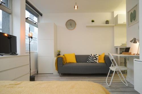 a living room with a couch and a table at New Refurbish Studio to rent in Euston - Central London in London