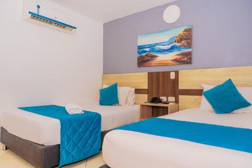 En eller flere senge i et værelse på Hotel Sabana del Sinu