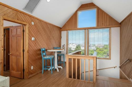 a room with wood paneling and a table and chairs at How You Dune - Dog-Friendly Semi-Oceanfront in Avon