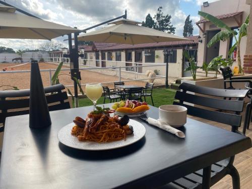 a table with a plate of pasta and a glass of wine at Forsen Kerkouen in Kerkouene