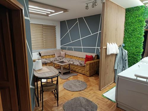 a living room with a couch and a table at JACUZZI for RELAX - HOLLYWOOD Apartment, STUP, Sarajevo near Airport in Sarajevo