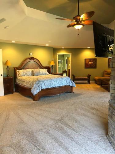 a bedroom with a large bed and a ceiling fan at Splash in the Smokys ! in Sevierville