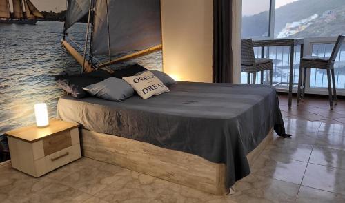 a bed with pillows on it in a room at Ocean Whisper suite in Tacoronte