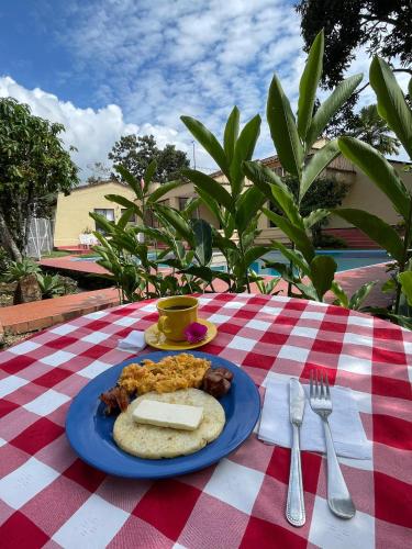 a blue plate of food on a picnic table at Casa Pance in Cali