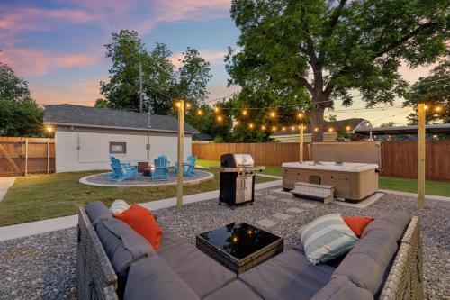 a backyard with a couch and a fire pit at 5 Beds Downtown OKC - Pickleball, Hot Tub, Firepit, GameRoom in Oklahoma City