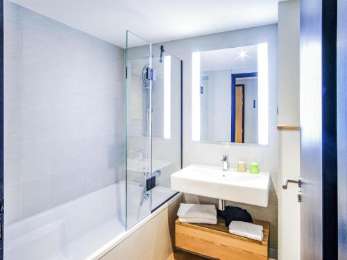 a bathroom with a sink and a shower at ibis Styles Albertville in Albertville