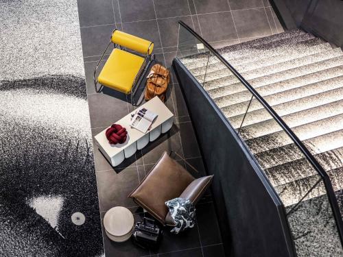 una vista dall'alto di un bagno con scale e una panca gialla di Tribe Amsterdam City ad Amsterdam
