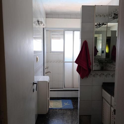 a white bathroom with a sink and a mirror at Alquiler temporal Casa céntrica in La Falda