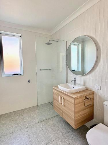 a bathroom with a sink and a mirror at Spring Haven in Wagga Wagga