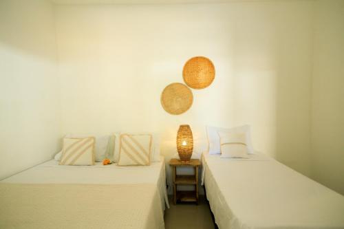 two beds sitting next to each other in a room at Casa George Trancoso in Trancoso