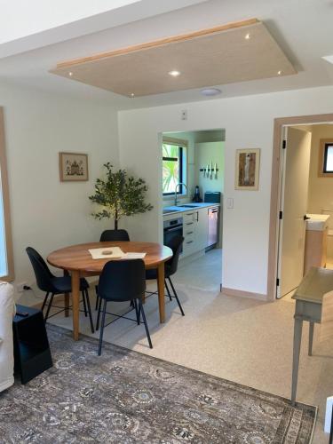 a kitchen and dining room with a table and chairs at Wilden Apartments in Queenstown
