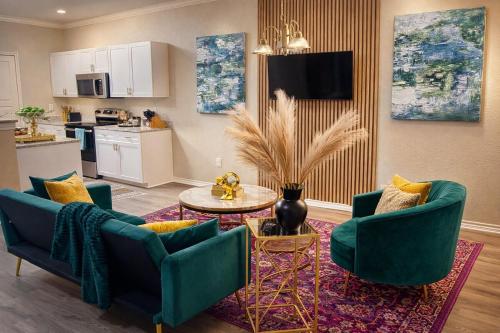 ein Wohnzimmer mit 2 blauen Stühlen und einem Tisch in der Unterkunft Upscale Condo Downtown Memphis Walk to Beale St in Memphis