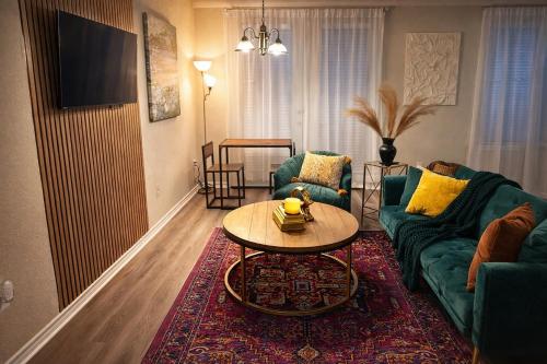 a living room with a couch and a table at Modern Condo Prime Area 1 min to Beale Street Gated Parking in Memphis
