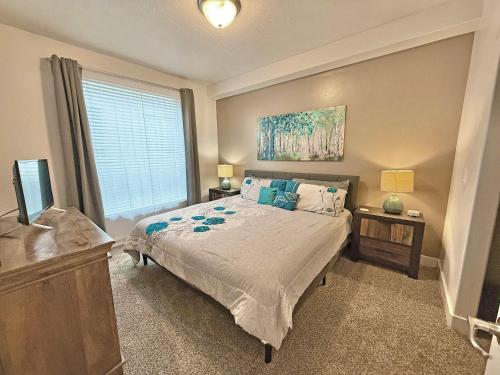 a bedroom with a bed and a window at Spacious 2-Bedroom Urban Oasis in Salt Lake City