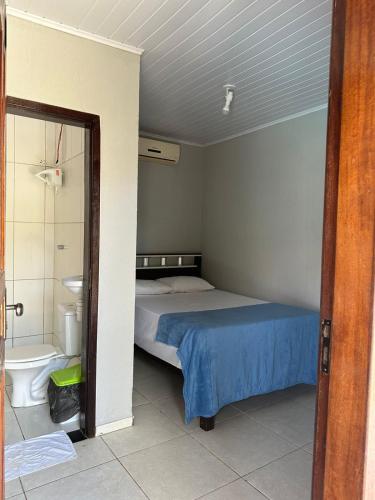 a bedroom with a bed and a bathroom with a shower at Casa Aiyra in São Miguel dos Milagres