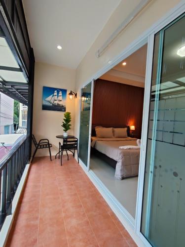 a bedroom with a bed and a table on a balcony at Chotam 2 bedroom flat Townhouse in Nathon Bay