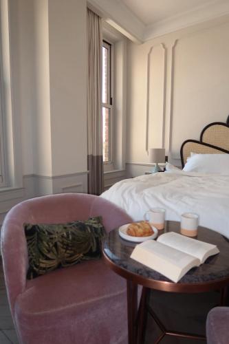 a room with a bed and a table and a chair at The Hoxton, Downtown LA in Los Angeles