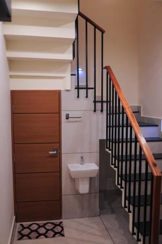 a bathroom with a toilet next to a staircase at G' de CASA in Varkala