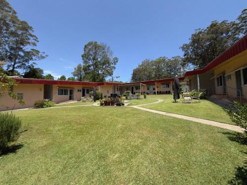 a row of buildings with a grass yard at Major Innes Motel in Port Macquarie