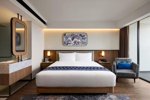 Ένα ή περισσότερα κρεβάτια σε δωμάτιο στο Oakwood Yogyakarta