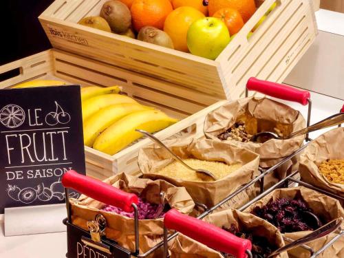 a display of fruits and vegetables in wooden baskets at ibis Paris Bastille Opera in Paris