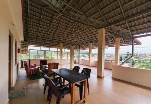 a dining room with a table and chairs at Nellakki Homestay in Madikeri