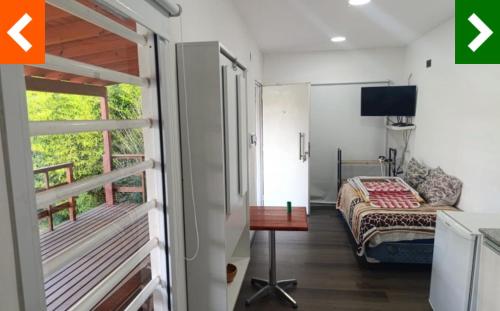 a small bedroom with a bed and a balcony at Cabaña Habibi in Potrero de Garay