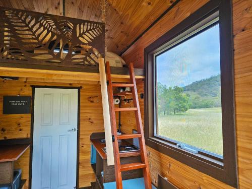 a room with a ladder and a window in a cabin at Anakie Gorge Getaway Tiny House 1 by Tiny Away in Staughton Vale