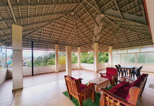 a living room with a table and chairs at Nellakki Homestay in Madikeri