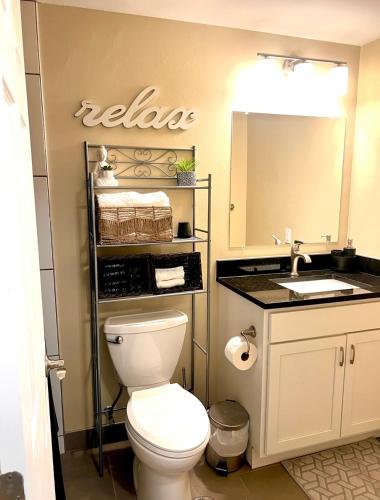 a bathroom with a toilet and a sink at The Nest At Twelve in Detroit