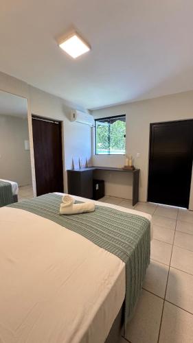 En eller flere senge i et værelse på Guest House - 2 Suites Independentes