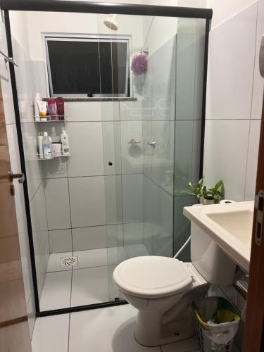 a bathroom with a shower with a toilet and a sink at Village do Sol 3 - Apt compartilhado in Maioba