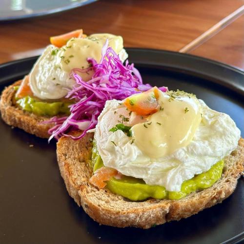 a plate with a sandwich with eggs and vegetables at Casa Verde Cliff Resort & Spa in Camotes Islands