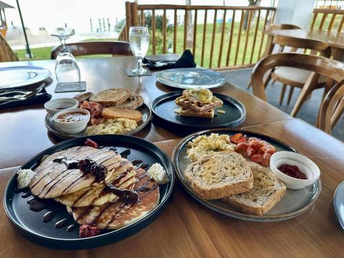 a table with plates of breakfast food on it at Casa Verde Cliff Resort & Spa in Camotes Islands