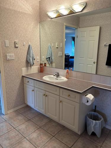 a bathroom with a sink and a mirror at Cozy getaway with a view! in Fairmont Hot Springs