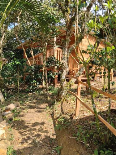 a wooden house in the woods with a fence at Cabaña Campestre - La Gloria in Guadalupe