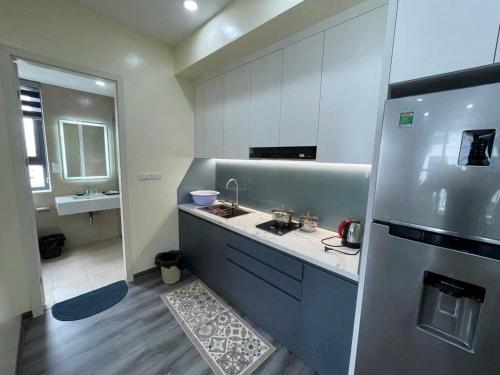 a kitchen with a sink and a refrigerator at The Timegarden Homestay in Ha Long