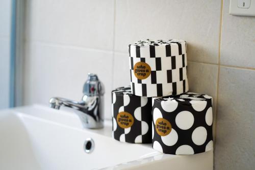 two polka dot towels sitting on a bathroom sink at Sunny Manly Escape 2 min walk to beach in Sydney