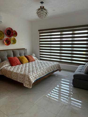 a bedroom with a bed and a large window at Mirador 28 in Platanitos