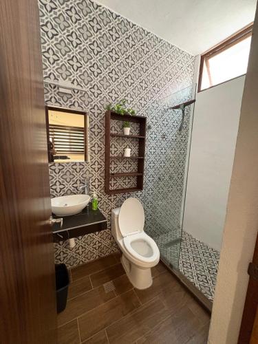 a bathroom with a toilet and a sink at Mirador 28 in Platanitos