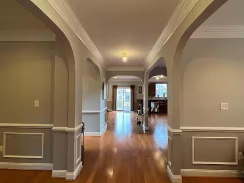 an empty room with a hallway with wood floors and ceilings at 25 Lux King Suite 1 - Private Bath, Nonsmoking in Arlington