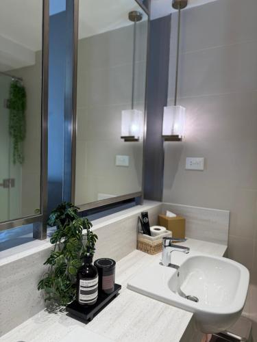 a bathroom with a sink and a mirror at Hotel Residence at Novotel in Manila